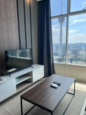 a living room with a tv and a coffee table at Sky Suite KLCC By near klcc in Kuala Lumpur