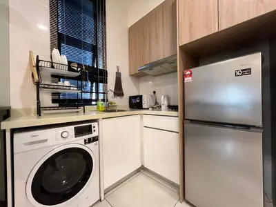 a kitchen with a dishwasher and a washer at Regalia Residences and suits By Comfortcorner in Kuala Lumpur