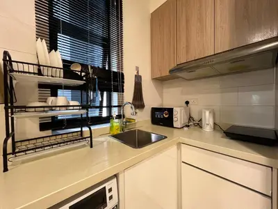 a kitchen with a sink and a microwave at Regalia Residences and suits By Comfortcorner in Kuala Lumpur