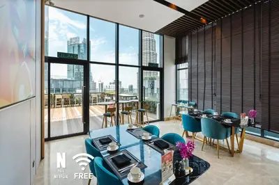 a dining room with a view of the city at Comfy 1 BR unit 2 mins from KLCC in Kuala Lumpur