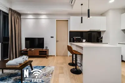 a kitchen and living room with a tv and a table at Comfy 1 BR unit 2 mins from KLCC in Kuala Lumpur