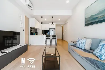 a living room with a couch and a table at Comfy 1BR with Twin Towers View in Kuala Lumpur
