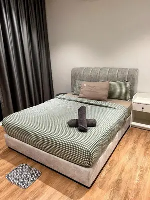 a bed with a hat on it in a room at Comfort Cove in Kuala Lumpur