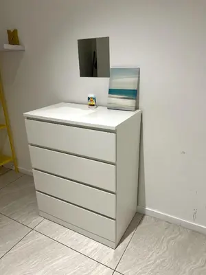 a white dresser with a mirror on top of it at Comfort Cove in Kuala Lumpur