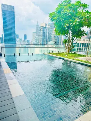 a swimming pool with a city in the background at AXON RESiDENCE AT SERViCE APARTMENT in Kuala Lumpur