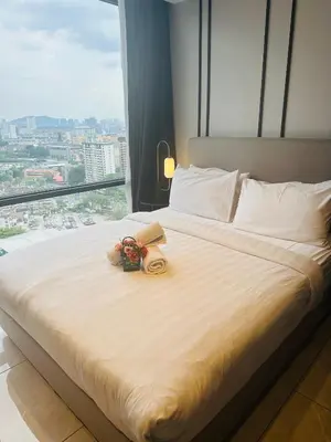 a bed in a hotel room with a large window at AXON RESiDENCE AT SERViCE APARTMENT in Kuala Lumpur