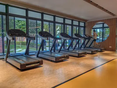 a row of treadmills in a gym with windows at Kuala Lumpur M Vertica Residence I Big Family Homestay \u5927\u5bb6\u5ead\u9002\u4f4f I Walking distance to MRT I \u9a6c\u4e2d\u82f1\u6587\u670d\u52a1 I Malay English Chinese in Kuala Lumpur