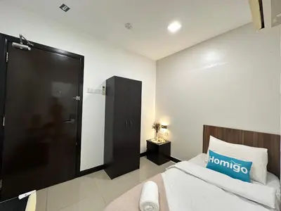 a bedroom with a bed and a black door at Homigo - PWTC in Kuala Lumpur