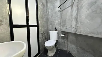 a bathroom with a white toilet and a sink at Homigo - PWTC in Kuala Lumpur