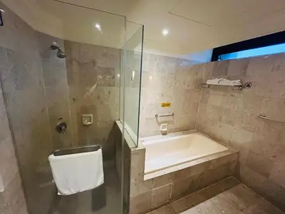 a bathroom with a shower and a tub and a sink at EVERYDAY SERVICE SUITE at TIMES SQUARE in Kuala Lumpur