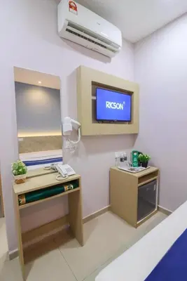 a hospital room with a reception desk and a tv at AQ Hotel Bukit Bintang in Kuala Lumpur