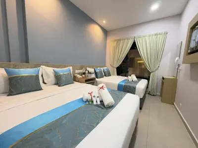 a hotel room with two beds and a window at AQ Hotel Bukit Bintang in Kuala Lumpur