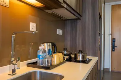 a kitchen with a sink and a counter top with pots and pans at One Bukit Ceylon AT Bukit Bintang Kuala Lumpur in Kuala Lumpur