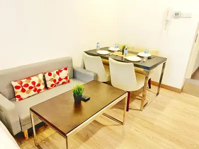 a living room with a table and a couch at One Bukit Ceylon AT Bukit Bintang Kuala Lumpur in Kuala Lumpur