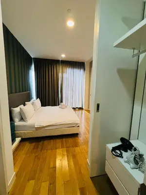 a bedroom with a white bed and a wooden floor at The Platinum KLCC by Dream Suites in Kuala Lumpur