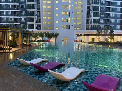 a swimming pool with chairs in the middle of a building at JMZ homestay in Kuala Lumpur