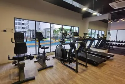 a gym with treadmills and exercise bikes in a room at 3BR LSH33 KL Duke Highway Genting Free Parking in Kuala Lumpur