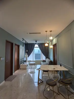 a living room with a table and chairs at Urban Sky Home with KLCC view at SKY SUITES Two Bed Rooms Apartment in Kuala Lumpur