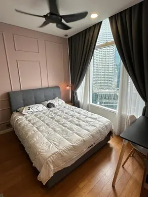 a bedroom with a bed with a ceiling fan and a window at Urban Sky Home with KLCC view at SKY SUITES Two Bed Rooms Apartment in Kuala Lumpur