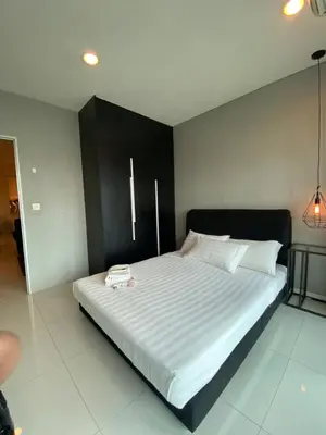 a bedroom with a large bed with white sheets at Summer Suites KLCC by Angel in Kuala Lumpur