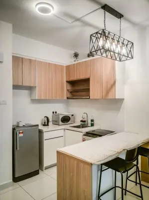a kitchen with wooden cabinets and white appliances at Scenic Living Homestay Studio in Kuala Lumpur