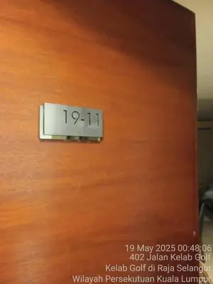 a clock on a wooden door in a room at 231tr facing golf view 3 rooms in Kuala Lumpur