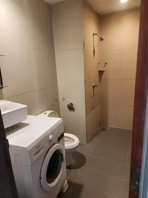 a bathroom with a washing machine and a toilet at 231tr facing golf view 3 rooms in Kuala Lumpur
