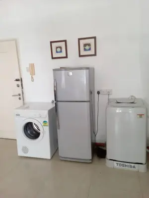 a kitchen with a refrigerator and a washing machine at Park view klcc by Alan in Kuala Lumpur