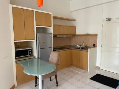 a kitchen with a glass table and a refrigerator at City centre, Bukit Bintang in Kuala Lumpur