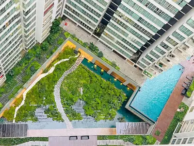 an overhead view of a pool in a city with tall buildings at Regalia Space Hostel in Kuala Lumpur