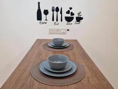 two cups and saucers on a wooden table at Summer Luxury Suites KlCC by ATIQ in Kuala Lumpur