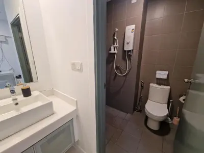 a bathroom with a shower and a toilet and a sink at Summer Luxury Suites KlCC by ATIQ in Kuala Lumpur