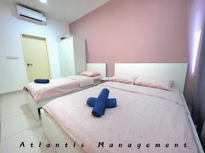 two beds in a room with blue towels on them at Parc 3, Taman Pertama, Kuala Lumpur By Atlantis Management in Kuala Lumpur
