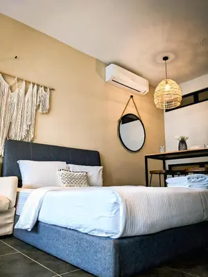 a bedroom with a large bed and a desk at Scarletz Suites KLCC by IH in Kuala Lumpur