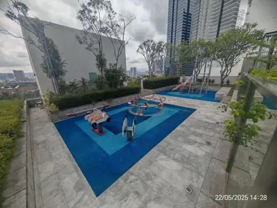 an overhead view of a swimming pool with two slides at Icon Residence in Kuala Lumpur