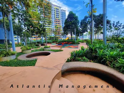 a park with benches and plants and a building at Parc 3 KL South Cozy Apartment, Walking Distance to AEON Maluri & Sunway Velocity in Kuala Lumpur