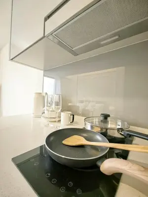 a frying pan on top of a stove in a kitchen at TRX Agile Bukit Bintang Deluxe 8 pax Family Suites in Kuala Lumpur