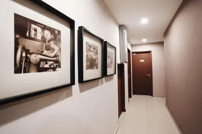 a hallway with four framed pictures on the walls at Hotel 1000 Miles in Kuala Lumpur