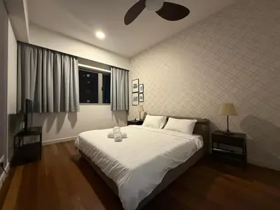 a bedroom with a large bed with white sheets at Kuala Lumpur Digital Work Base in Kuala Lumpur