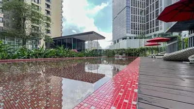 a pool in the middle of a city with buildings at Kuala Lumpur Digital Work Base in Kuala Lumpur