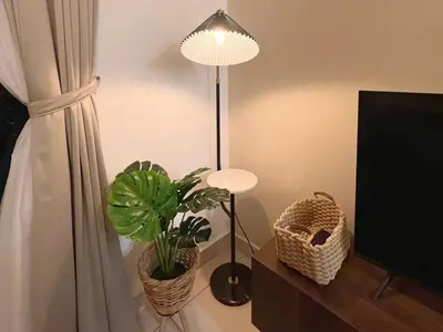 a lamp and a potted plant next to a window at TrionKL Luxury Stay 2BR Free Wi-Fi 10min to KLCC - Chinese Host in Kuala Lumpur