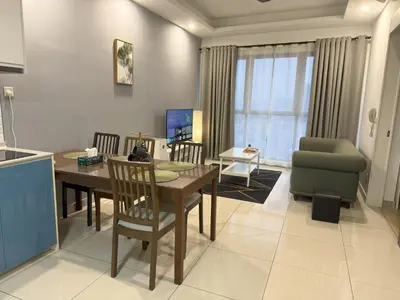 a kitchen and living room with a table and a chair at Continew Residence Studio Apartment in Kuala Lumpur