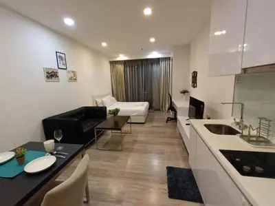 a kitchen and a living room with a bed and a couch at AK Residence in Kuala Lumpur