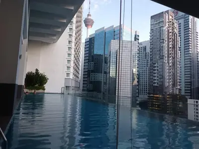 a swimming pool in a city with tall buildings at AK Residence in Kuala Lumpur