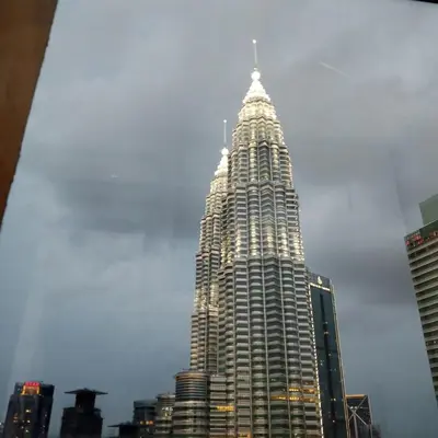 a tall building with a spire on top of it at Sleep in the Sky KLCC View in Kuala Lumpur