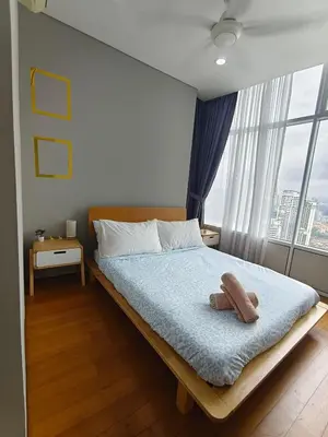 a bedroom with a bed with two towels on it at Sleep in the Sky KLCC View in Kuala Lumpur