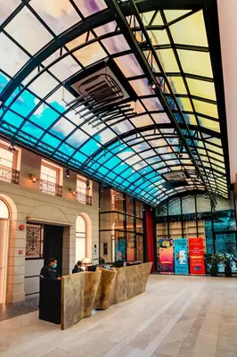 a large building with a glass ceiling and a lobby at Scarletz Luxury Suites KLCC in Kuala Lumpur