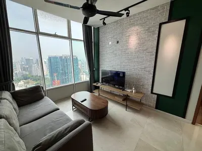 a living room with a couch and a large window at Sky Suites KLCC by Easy Nap in Kuala Lumpur