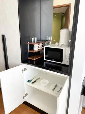 a small kitchen with a microwave and a counter at Sky Suites KLCC by Easy Nap in Kuala Lumpur