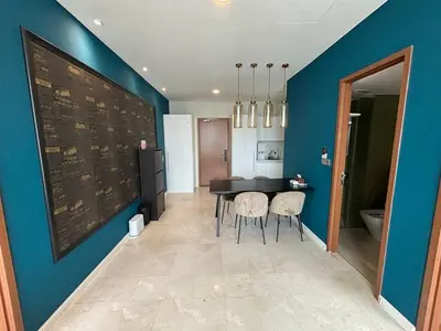 a dining room with a table and a blue wall at Sky Suites KLCC by Easy Nap in Kuala Lumpur